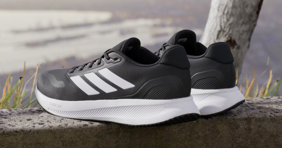 pair of black and white adidas sneakers at scenic overlook