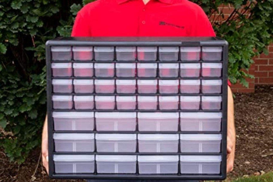 man holding plastic storage cabinet