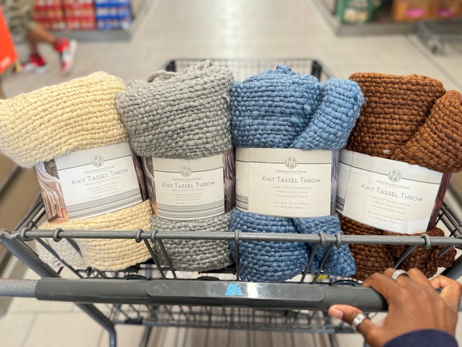 beige, gray, blue and brown throws in shopping cart 