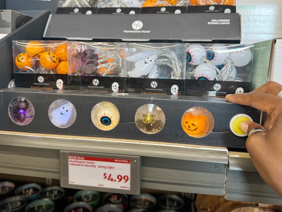 pumpkin, skeleton, and more halloween string lights on shelf in aldis store