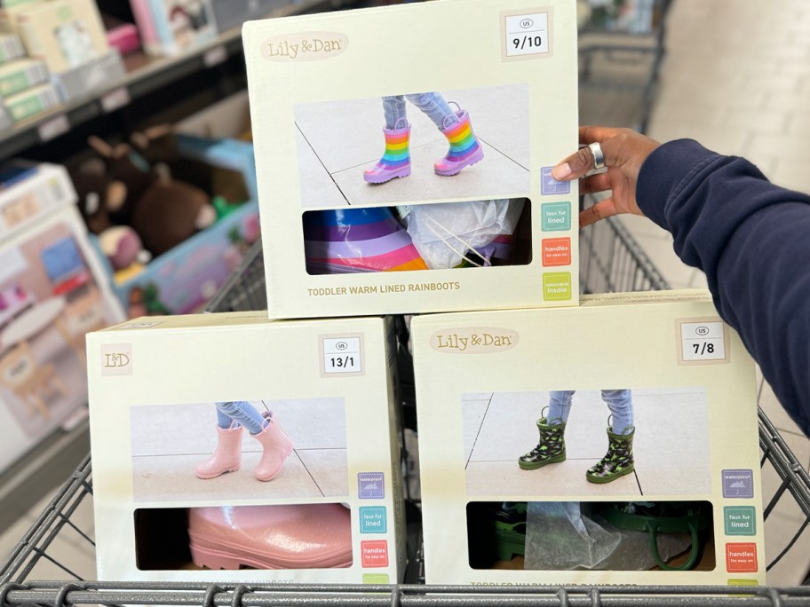 three boxes of rainboots in shopping cart 