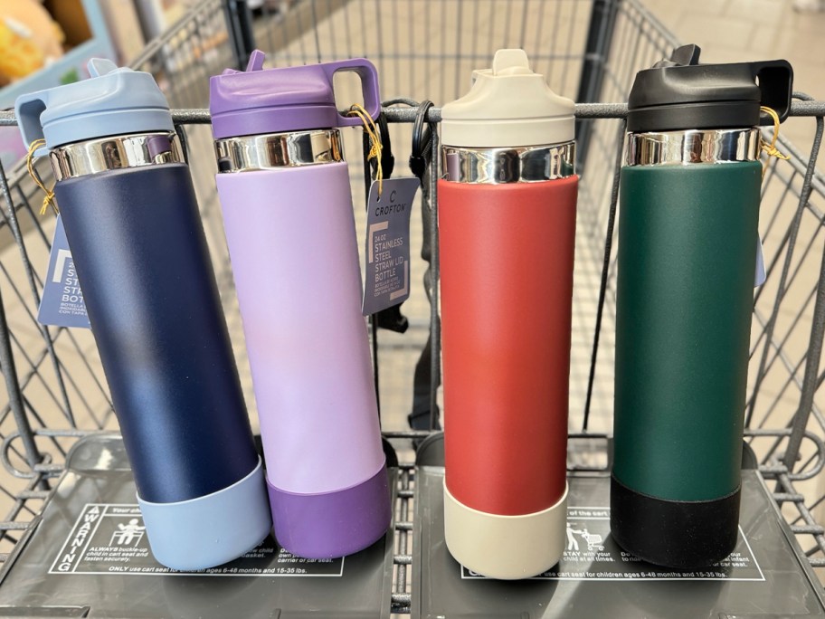 blue, purple, red and green water bottles in shopping cart 