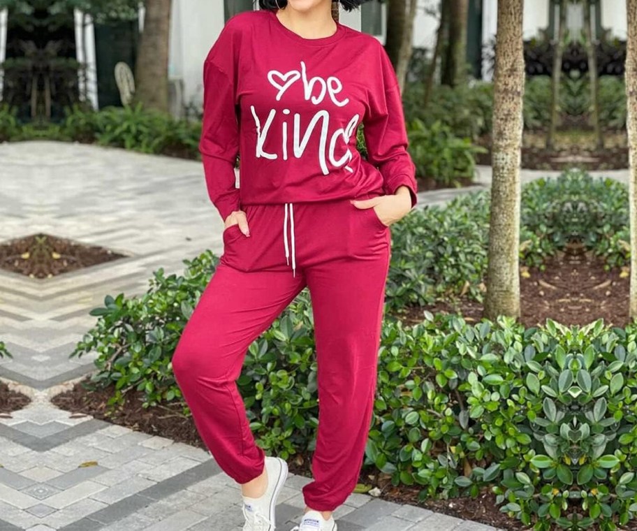 woman in maroon 'be kind' jogger set