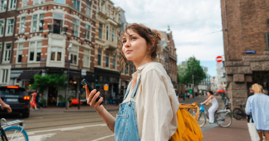 woman holding phone in new country