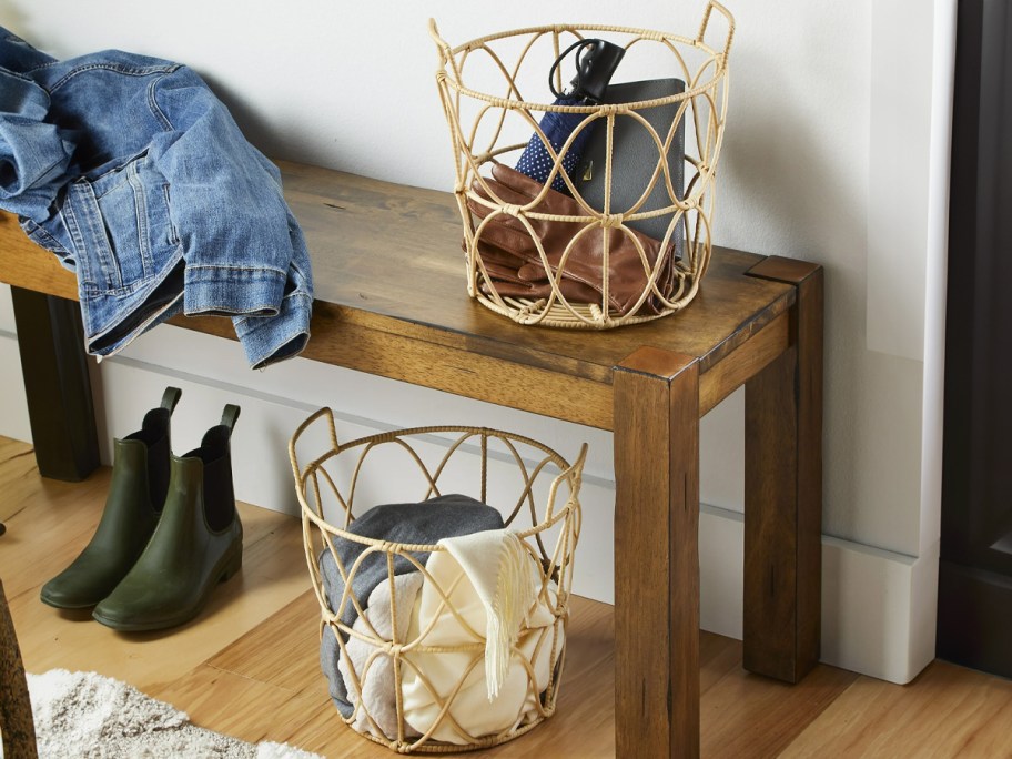 two storage baskets with shoes and scarfs sitting in entryway