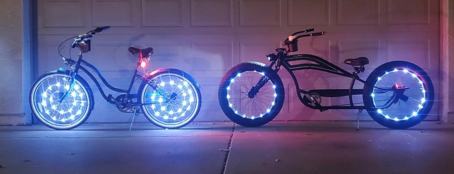 two bicycles with blue tire lights on rims