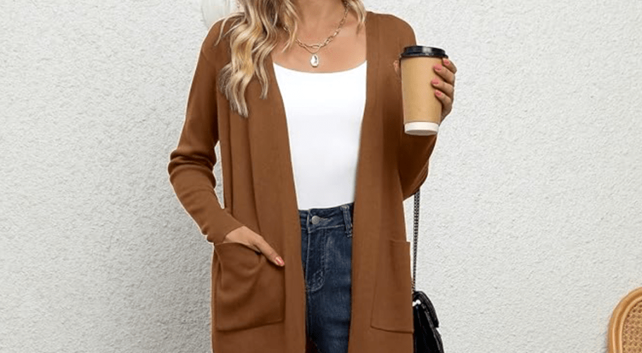 wearing brown cardigan and holding coffee