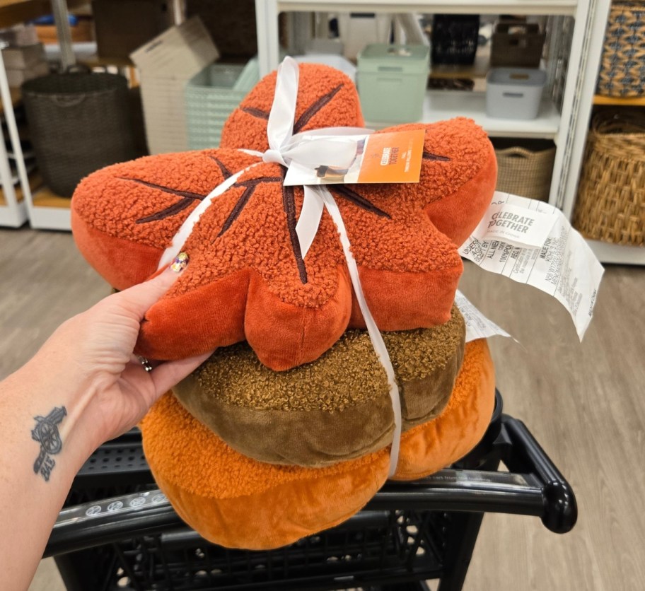 a stack of fall themed pillows shaped like fall foliage