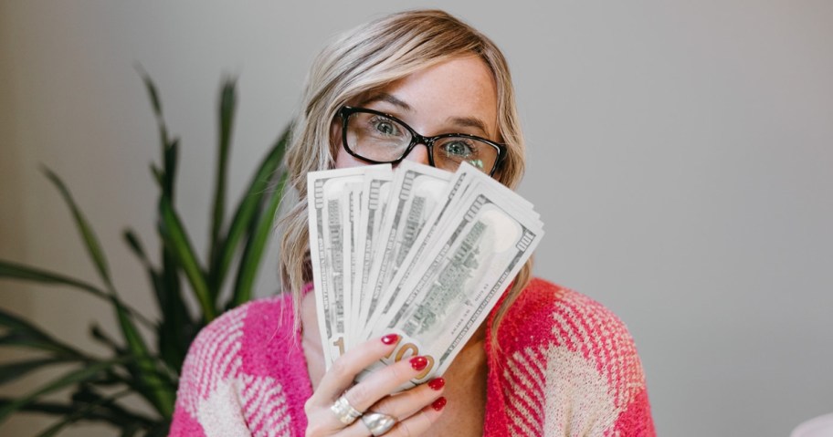 woman holding up money