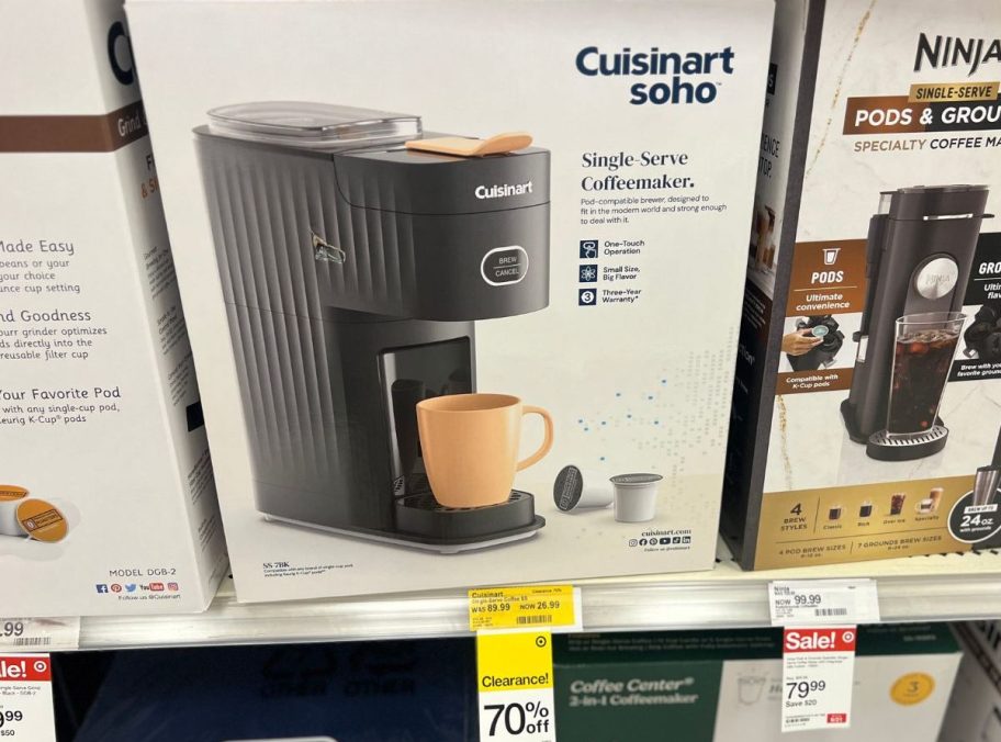 A Cuisinart single-serve coffee brewer in the box on a store shelf.