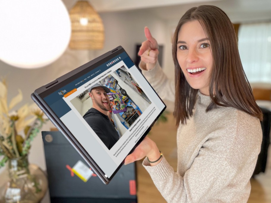woman holding laptop computer with hip2save black friday shopper giveaway voting page