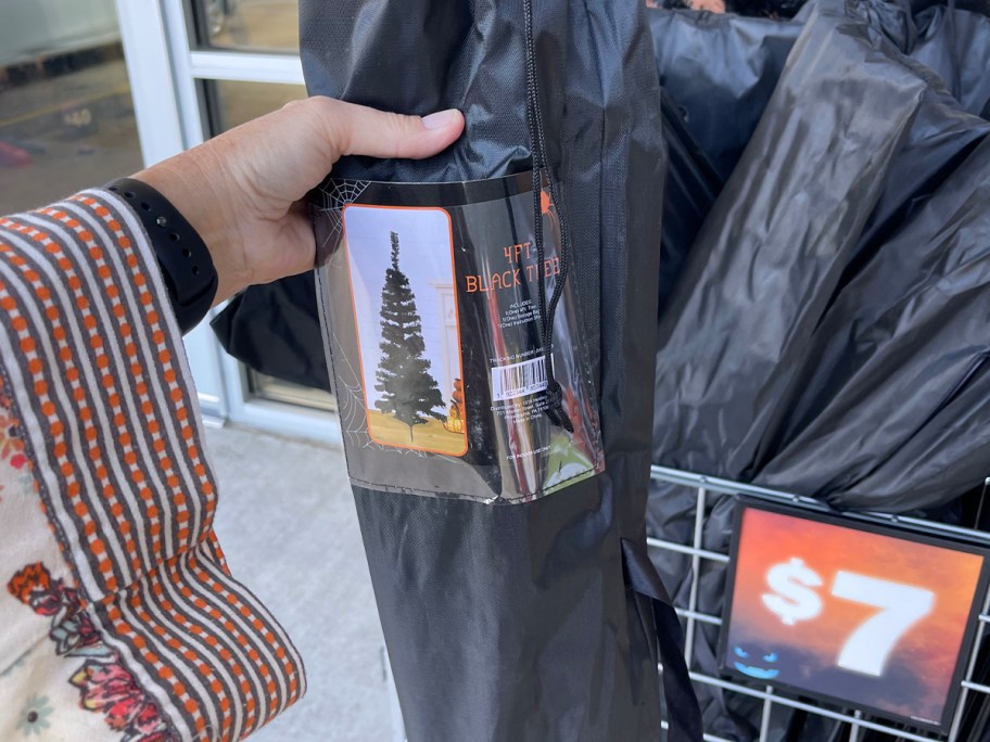 hand holding black tree bag 