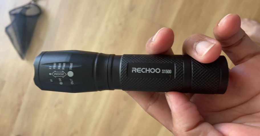 hand holding RECHOO Tactical Flashlight