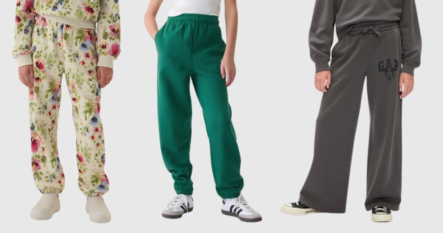 girl wearing tan and floral joggers, boy wearing green Gap joggers, and girl wearing grey GAP Mickey Mouse joggers