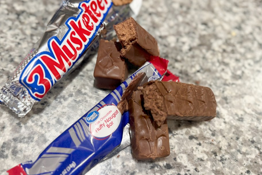 two nougat bars cut in half on top of wrappers