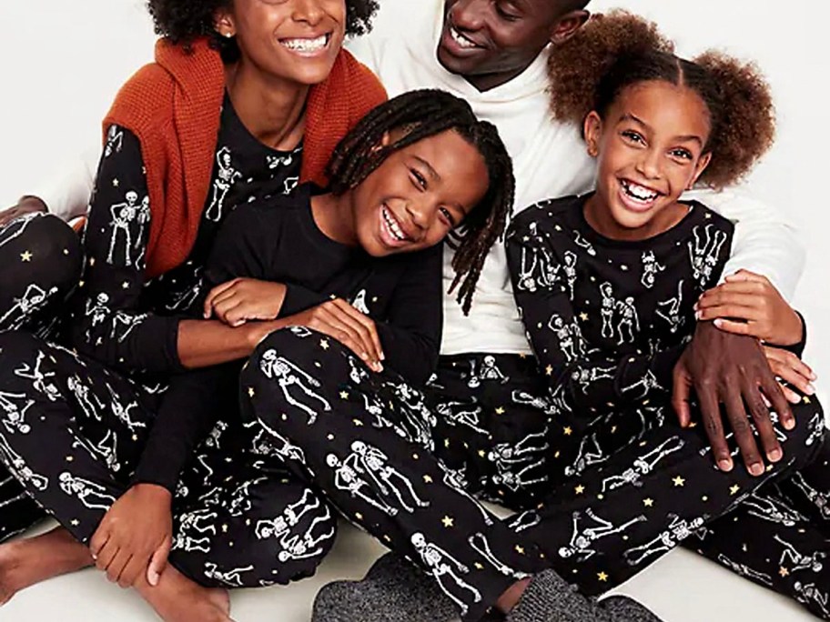 family wearing black and white skeleton matching pajama sets