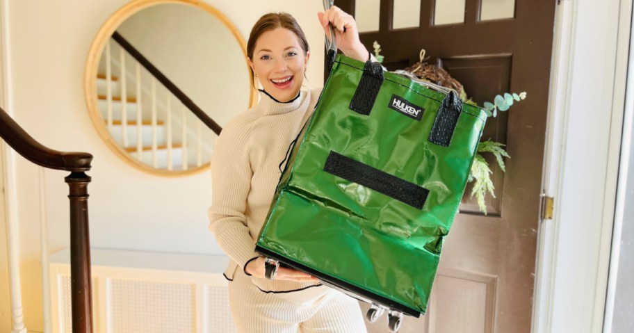 woman holding up a green hulken bag