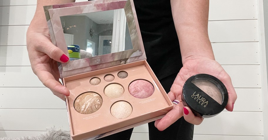 hands holding laura geller baked cosmetics