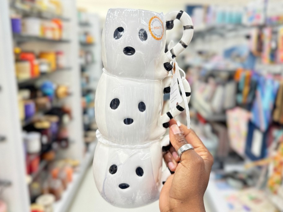 hand holding a set of 3 stacking ghost coffee mugs