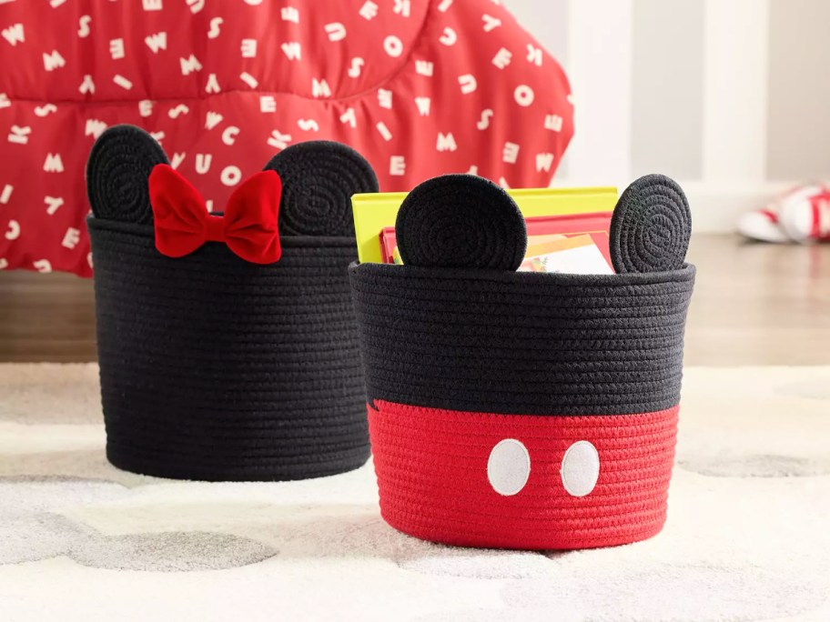 mickey and minnie mouse rope totes in front of a red comforter on a bed