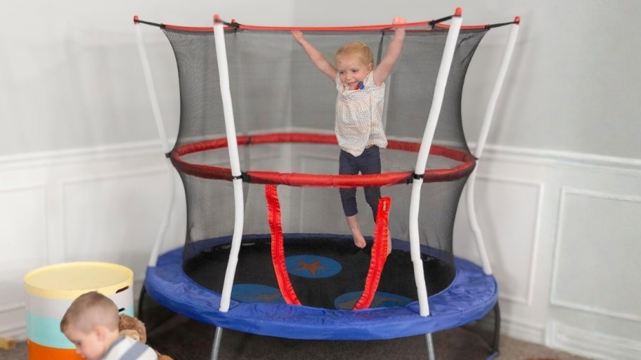 little girl jumping on a mini trampoline
