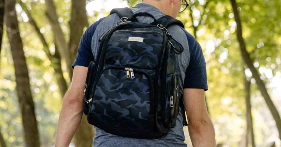 man wearing a blue camo baby diaper bag backpack