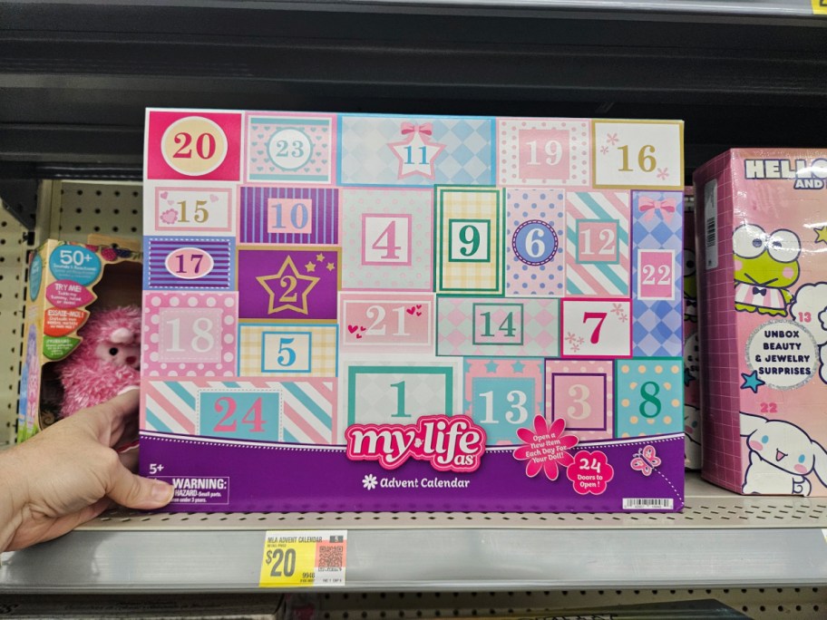 hand holding a my life as advent calendar on a walmart store shelf