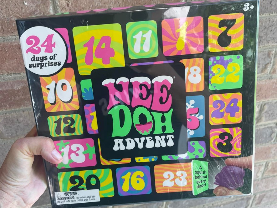 needoh advent calendar being held in hand against a brick wall