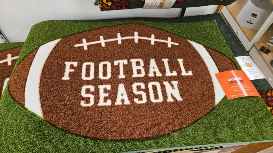 a doormat with a large football on it