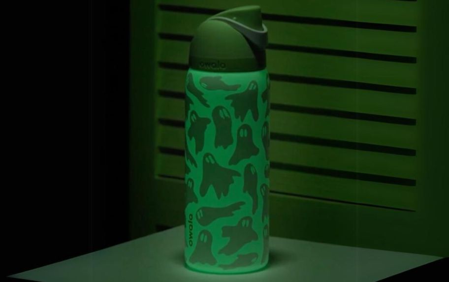 owala boo-ya water bottle glowing in the dark on a table top