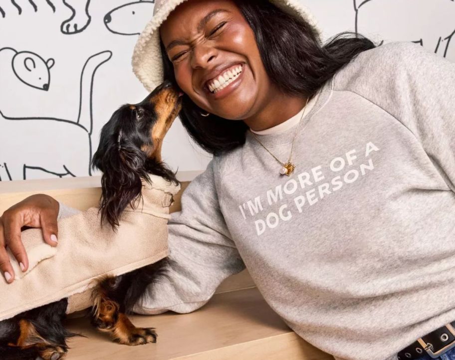 a woman and her dog sharing affection