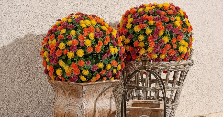 yellow, orange, and red faux mum spheres on planters