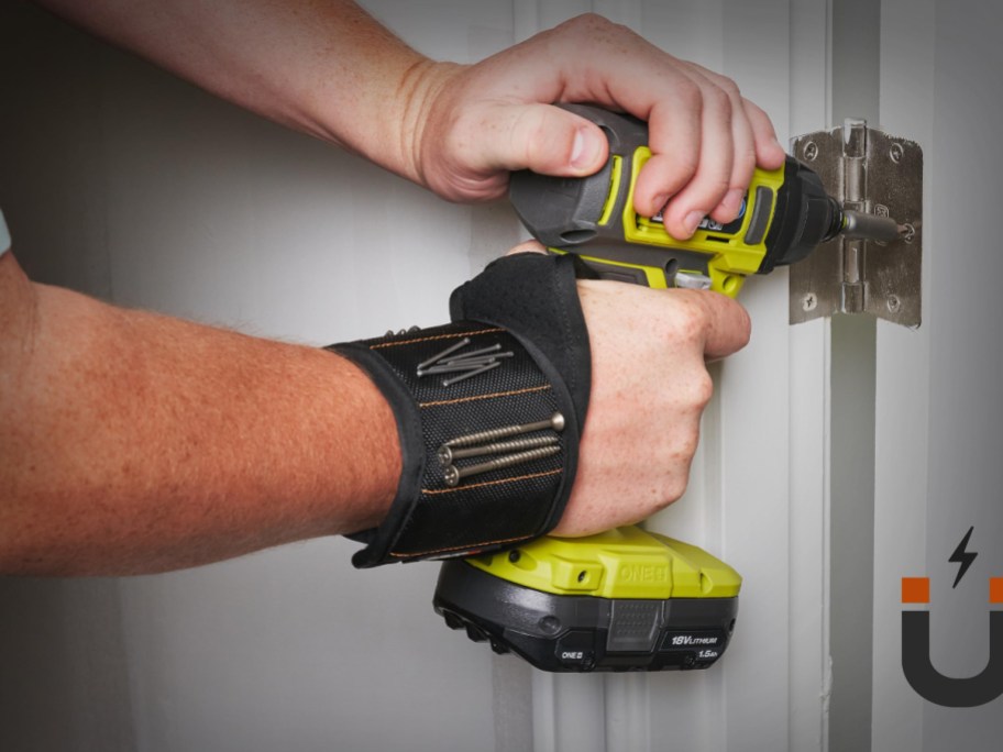 man using drill while wearing magnetic wristband