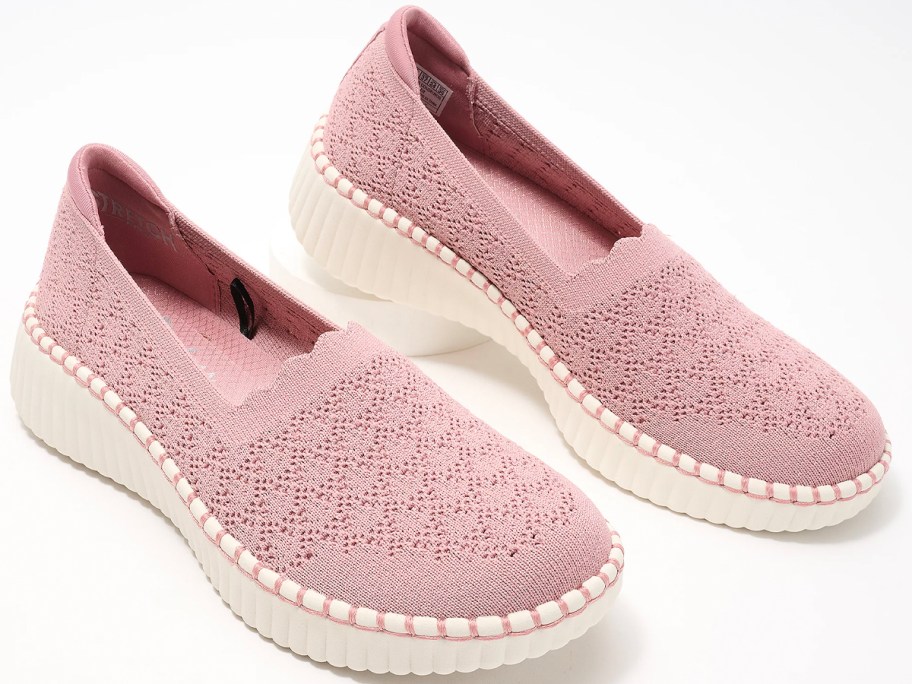 pair of pink slip on sketchers shoes 