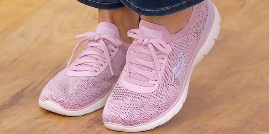 person wearing pink sketchers slip on shoes 