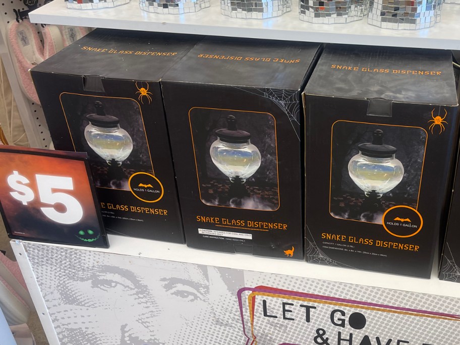 three snake drink dispensers on shelf 
