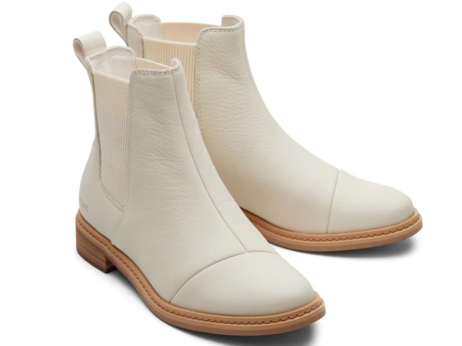 a pair of cream color women's boots