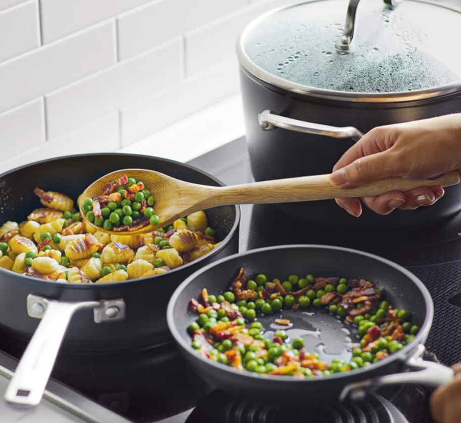 hand scooping food out of pan