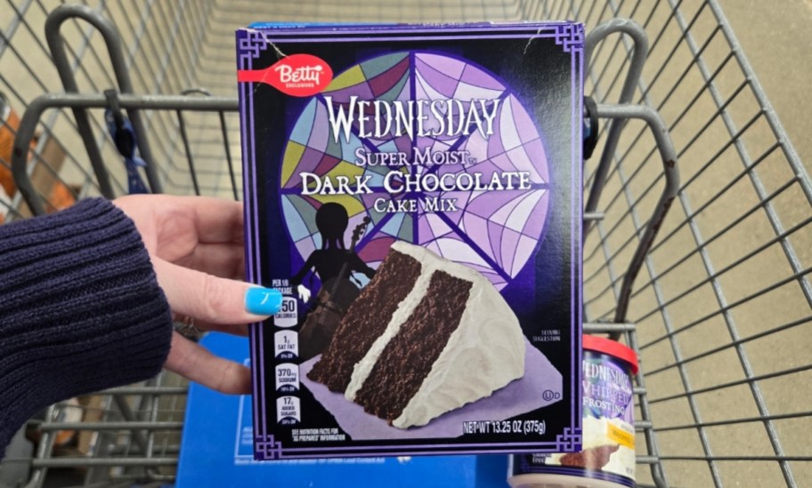 a womans hand holding a box of dark chocolate cake mix