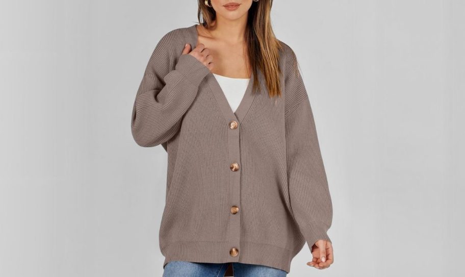 a model in a brown oversized cardigan