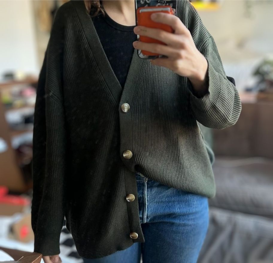 a woman in an army green oversized cardigan