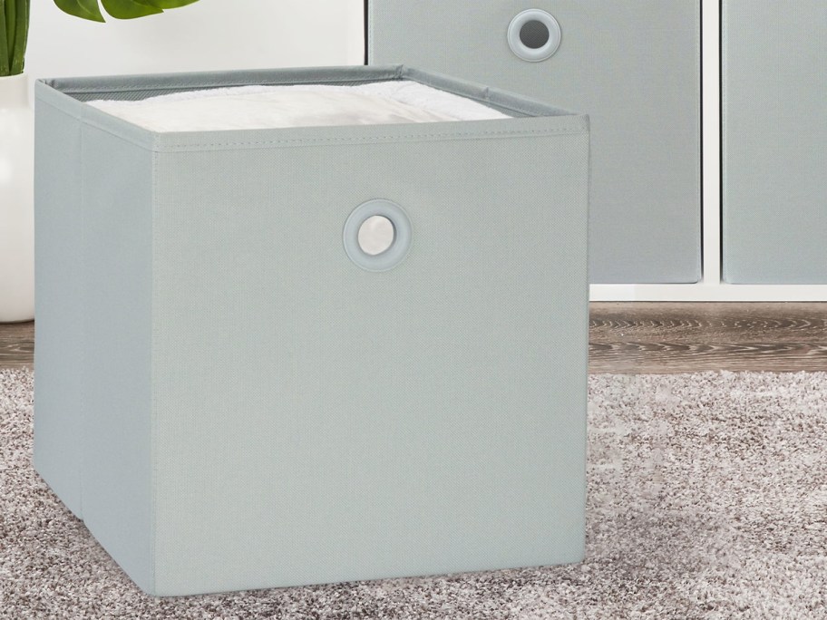 gray storage bin on floor 