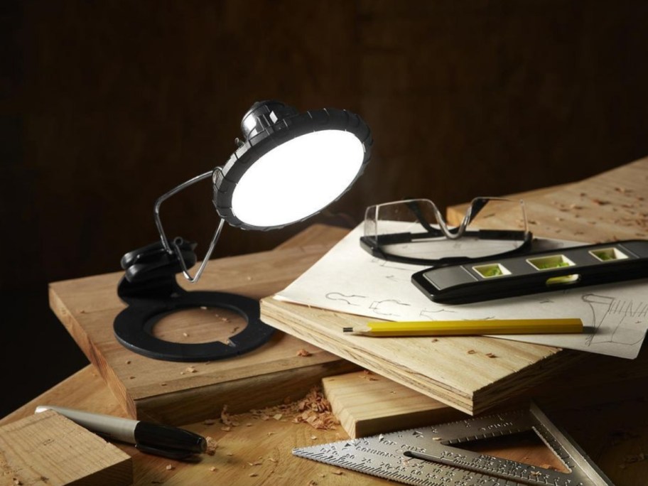 a black adjustable clip on work light on a work table