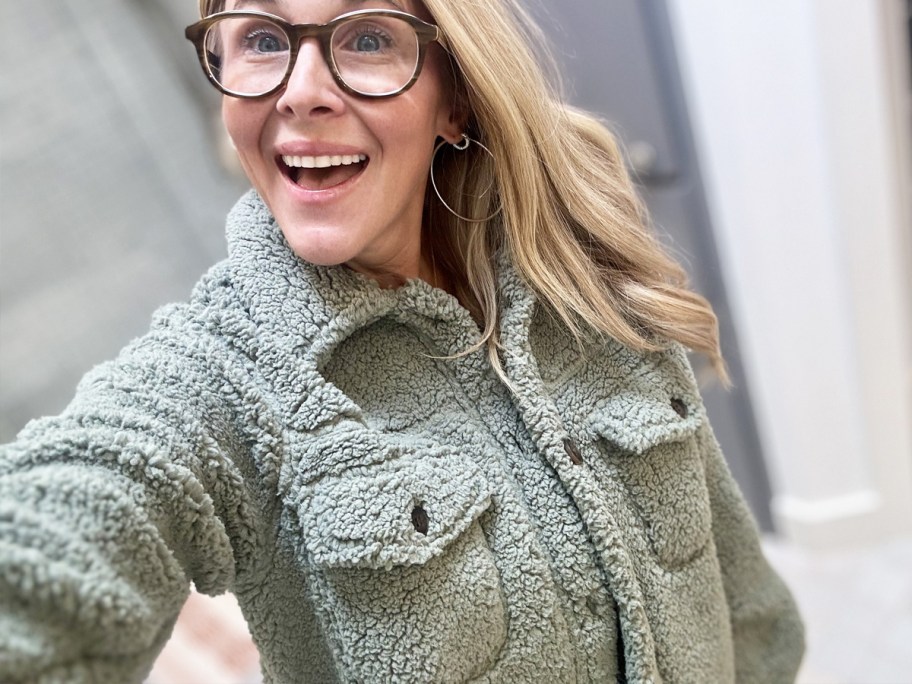 woman in a green sherpa jacket