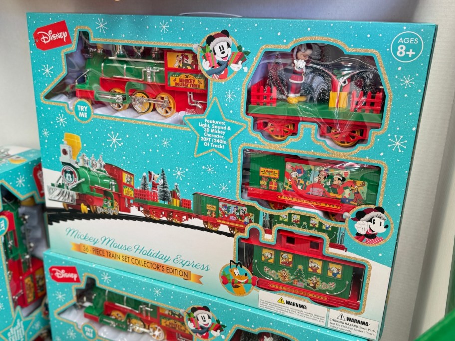 large blue box with a 36-Piece Battery Operated Mickey Mouse Holiday Express Train on a store display