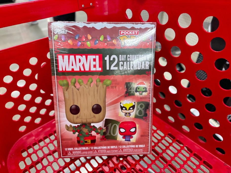 a Funko Countdown Calendar Marvel 12 Day Figures box in a store, cover has baby Groot, Spiderman, Wolverine POP figures and more on it sitting in a red Target shopping cart