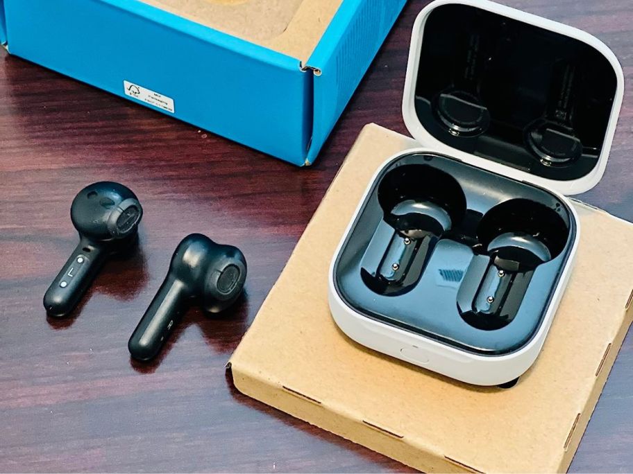 A pair of black earbuds on a table