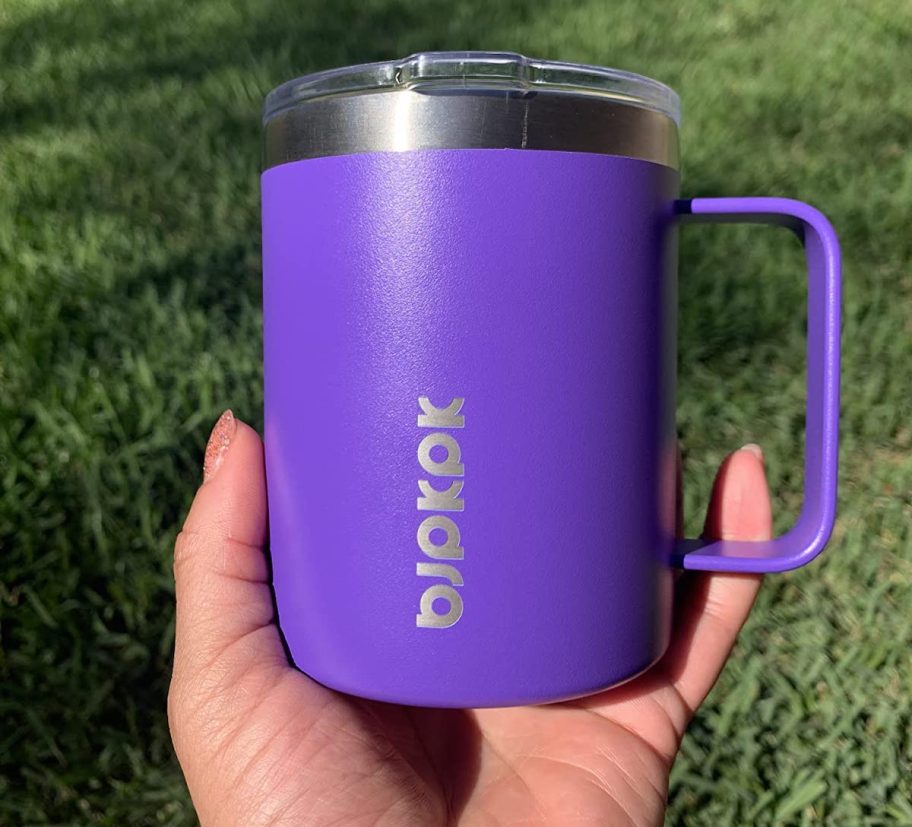 hand holding purple insulated mug