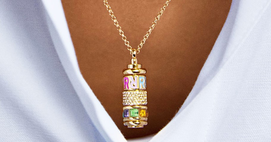 woman wearing a gold spinner charm necklace