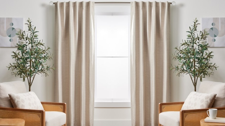 two blckout curtain panels hung over a window